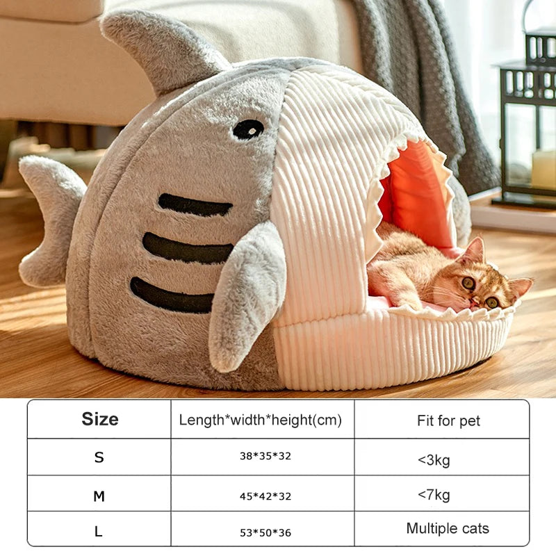 Cat lying in a shark-shaped pet bed with size chart below