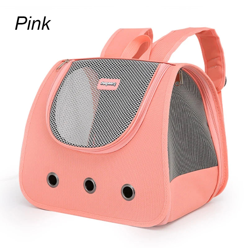Pink pet carrier with mesh sides on a white background