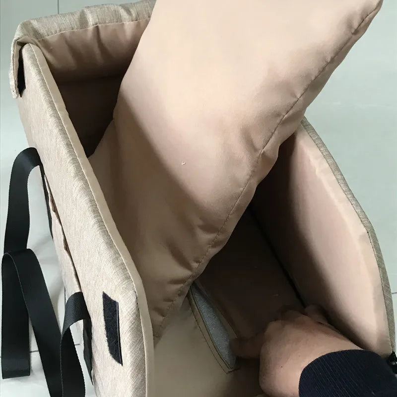 Close-up of a beige bag with a hand reaching inside, on a light gray background
