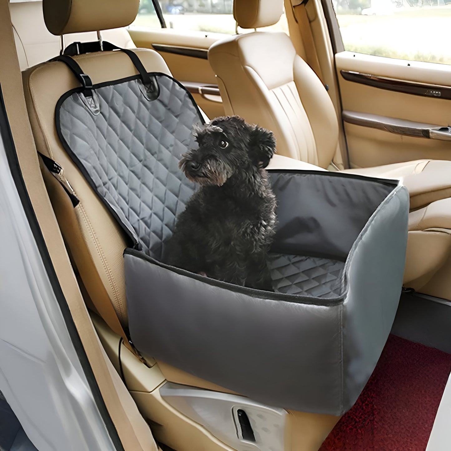 Dog sitting on a gray car seat cover in a vehicle