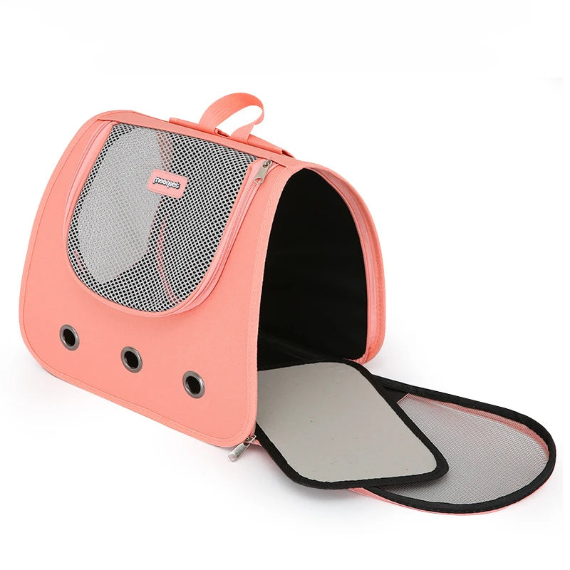Pink pet carrier with mesh sides on a white background