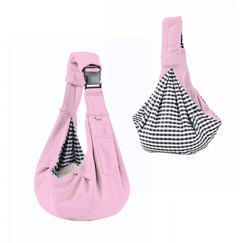 Pink pet sling with checkered interior on a white background