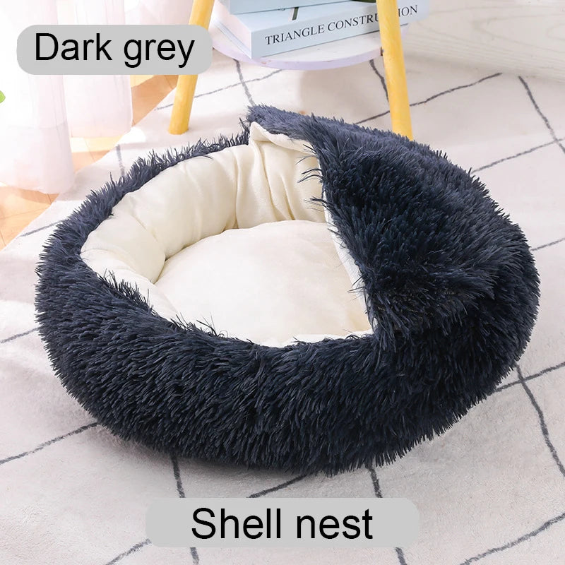 Dark grey shell nest pet bed on a light surface