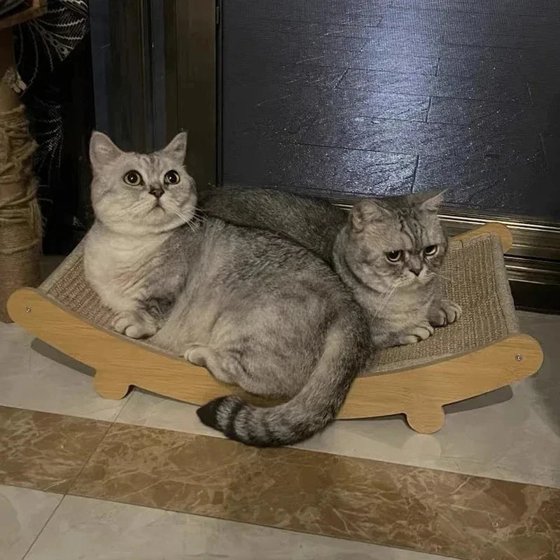 Two cats sitting on a wooden cat scratcher with a dark background