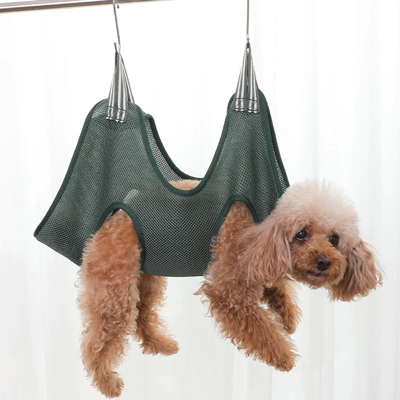 Dog hanging from a green mesh hanging pet grooming bag against a white background