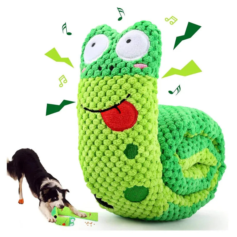 Green crocheted caterpillar toy with a dog playing with it on a white background