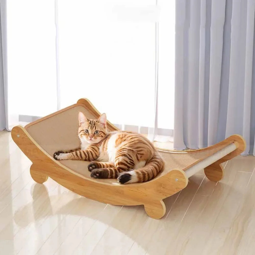 Cat lying on a cat scratch board in a bright room with light-colored floor and white curtains.