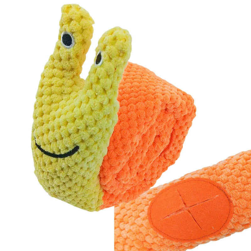 Plush toy snail with a smiling face on an orange shell against a white background