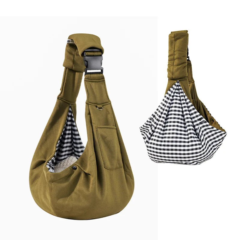 Brown pet sling with checkered interior on a white background