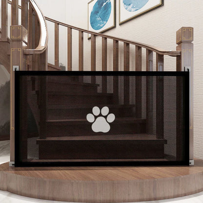 Black mesh pet gate with a paw design on a staircase