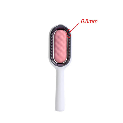Grooming brush with pink roller and white handle on a white background