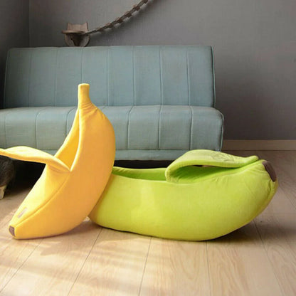 Two banana-shaped bean bags on a wooden floor with a gray couch in the background.