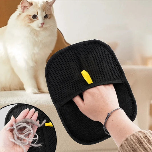 Black Pet Grooming Gloves with yellow tag held by a person, with a cat in the background.