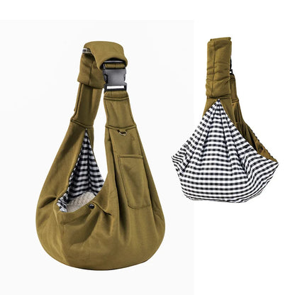 Brown pet sling with checkered interior on a white background